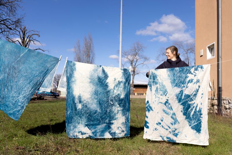 Carolin Lange hangs the processed cotton fabrics to dry.